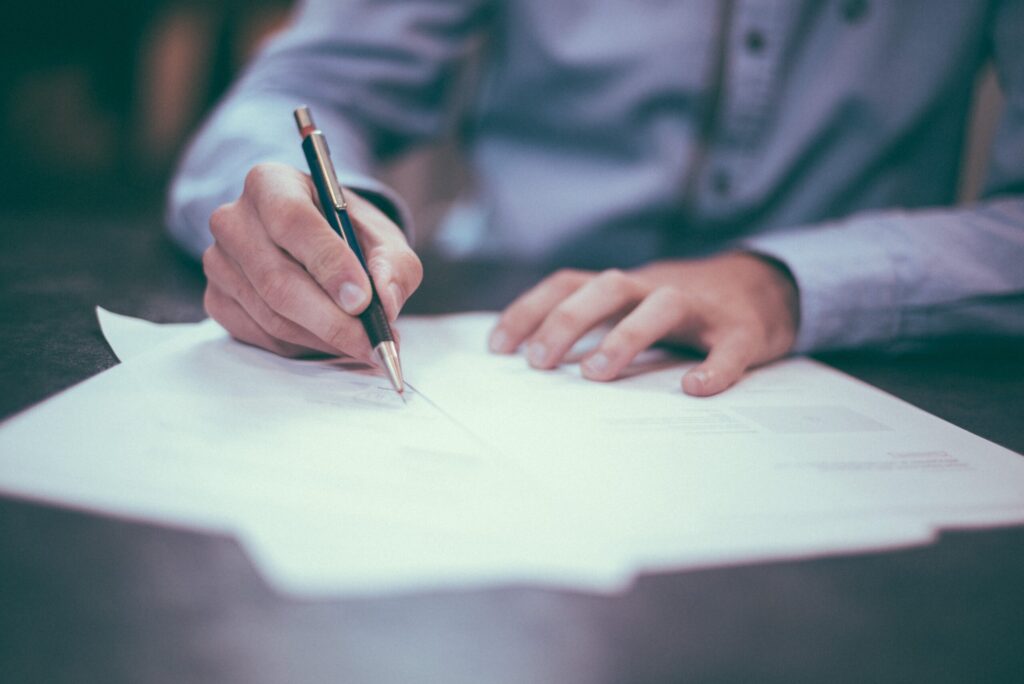 Man writing on paperwork