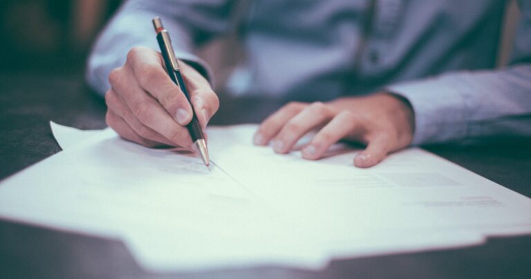 Man writing on paperwork