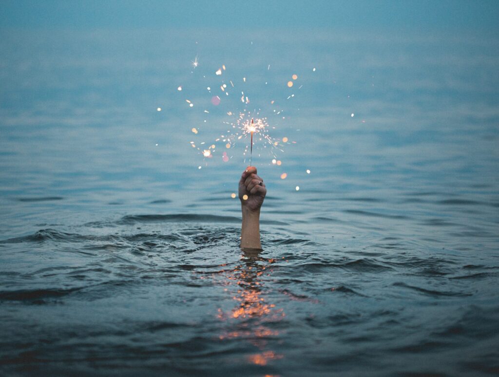 Firework in hand out of water