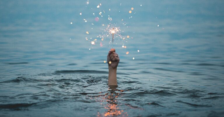 Firework in hand out of water