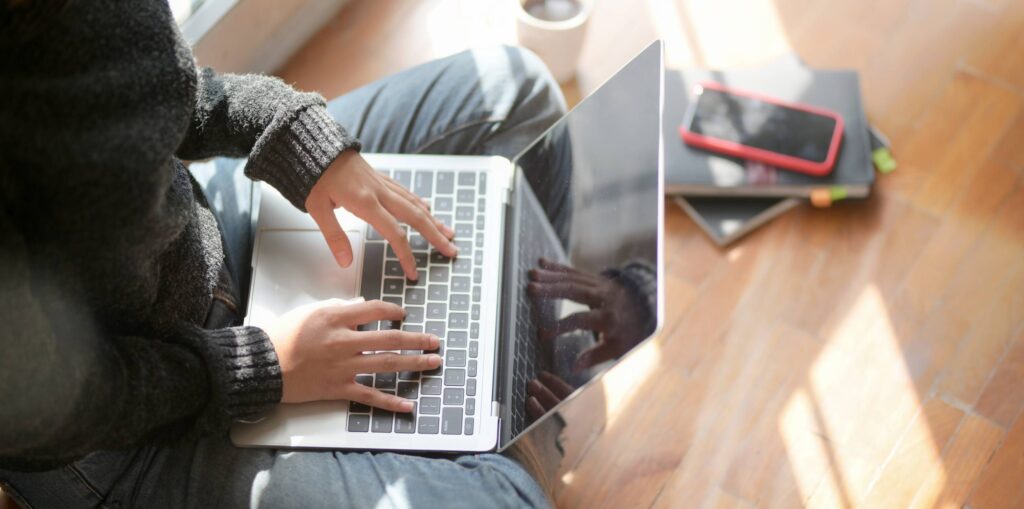 Woman sitting on floor with laptop