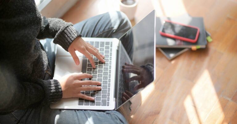 Woman sitting on floor with laptop