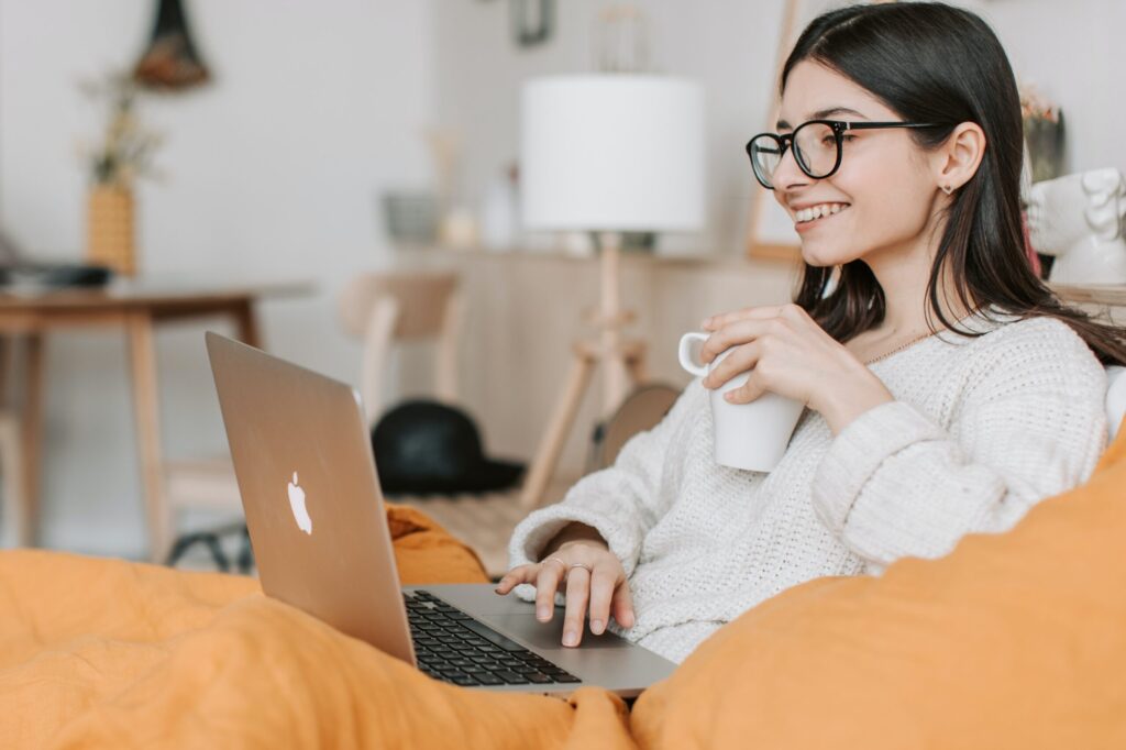 woman drinking coffee on laptop