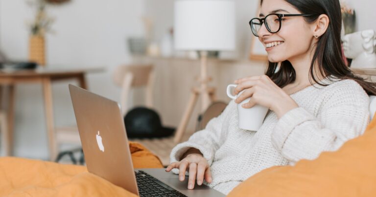woman drinking coffee on laptop