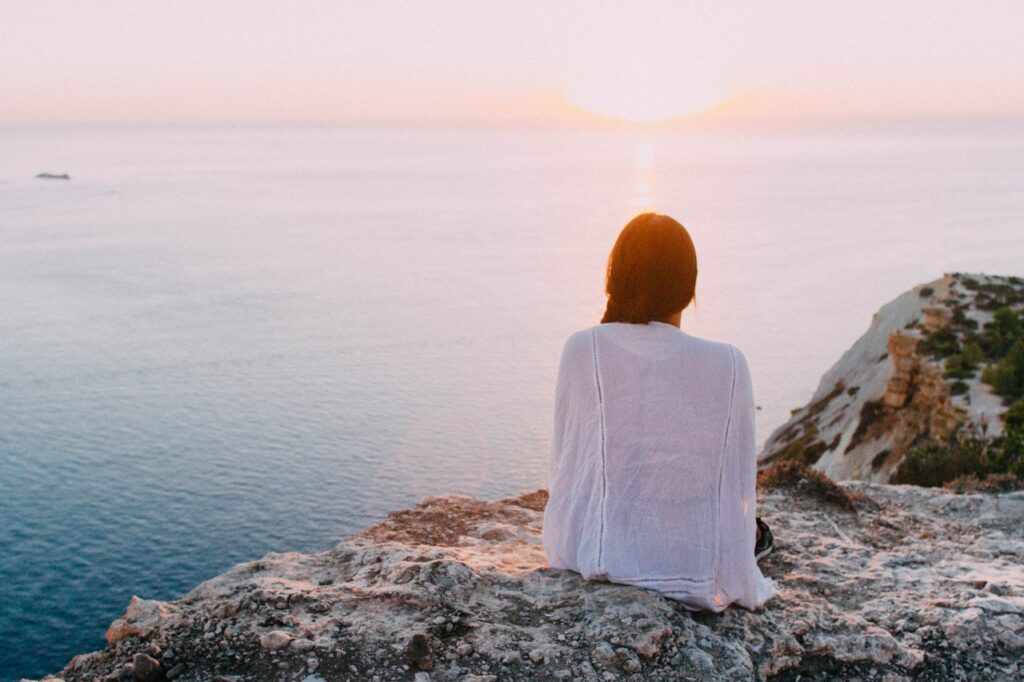 woman on a rock looking at the view