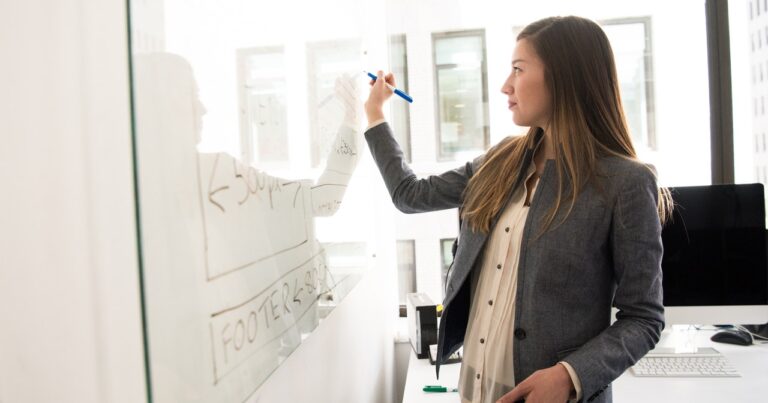 teacher writing on whiteboard