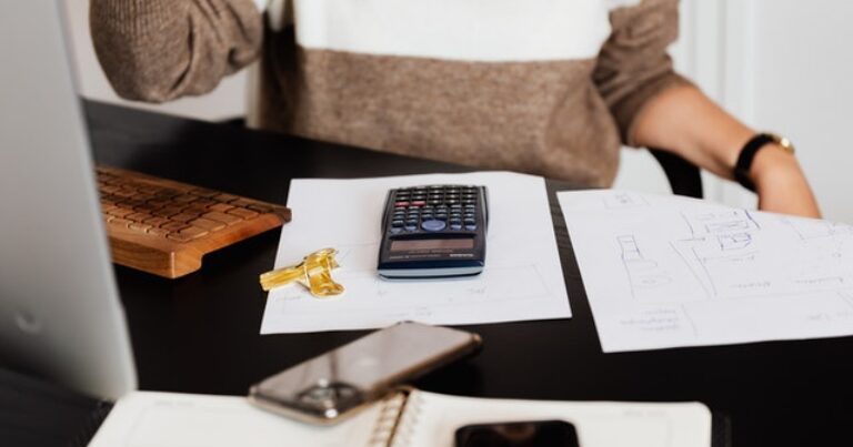 desk with calculator and paperwork