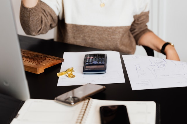 desk with calculator and paperwork