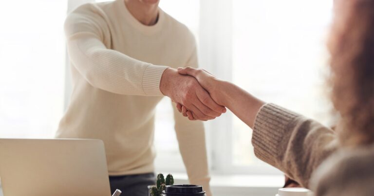 man and woman shaking hands