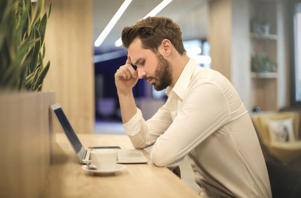 Man stressed on laptop