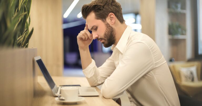 Man stressed on laptop