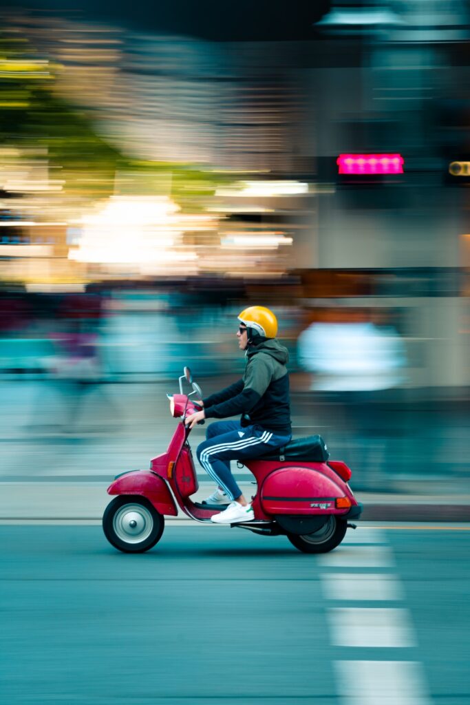 man on scooter riding fast