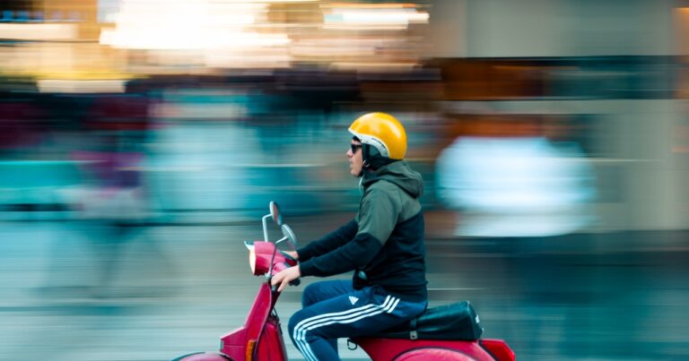 man on scooter riding fast