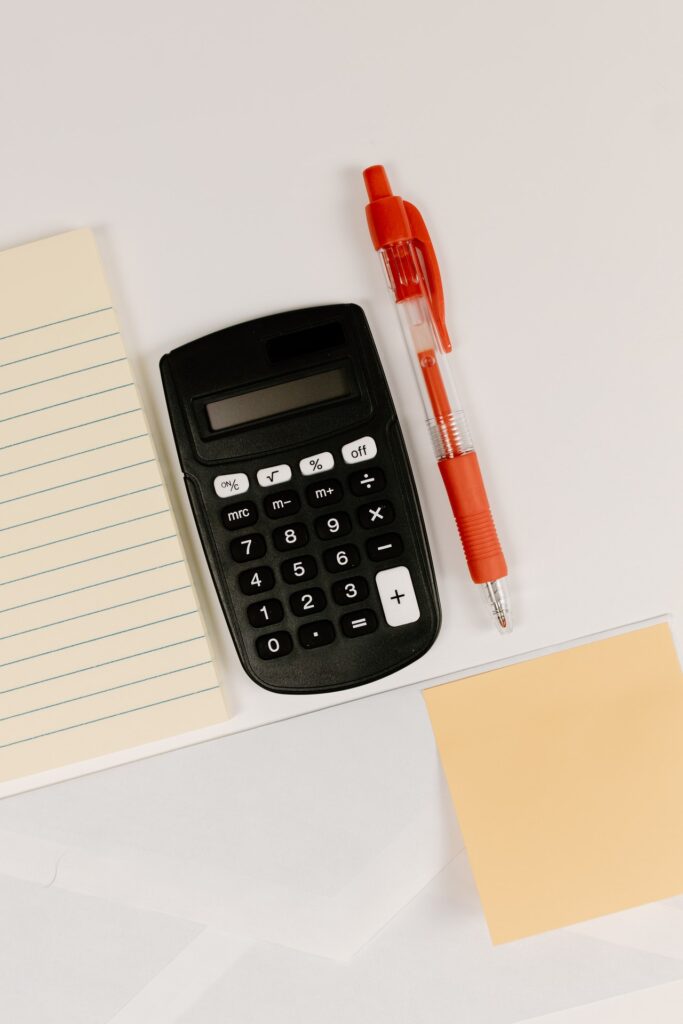 calculator and pen on desk