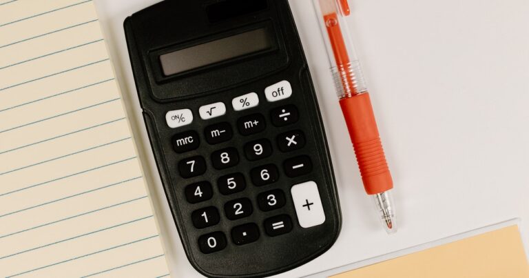 calculator and pen on desk