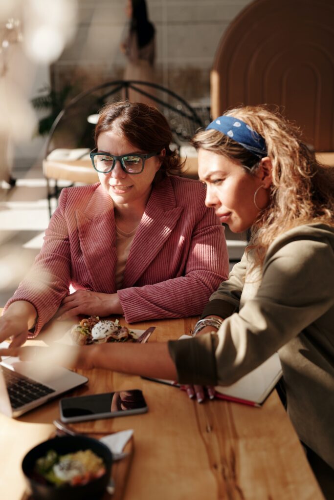 Two recruiters looking at a laptop